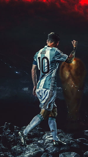 Lionel Messi in Argentina Number 10 Kit Standing on Rugged Rocks with Dramatic Red Sky HD phone wallpaper