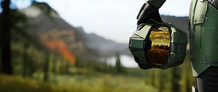 Halo Infinite Master Chief holding helmet in a misty forest landscape HD wallpaper