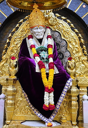 Shirdi Sai Baba Statue Seated on Golden Throne with Marigold Garland and Purple Robe HD phone wallpaper