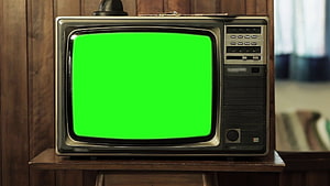 Vintage Retro Television Set Displaying Bright Green Screen on Wooden Stand HD wallpaper