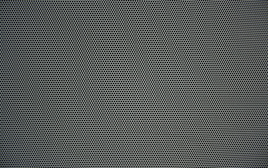 Close-up of perforated metal sheet with uniform circular holes and silver grid texture HD wallpaper