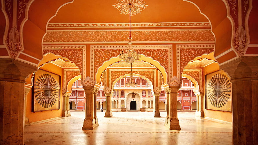 Ornate Indian Palace Courtyard With Intricate Arches And Warm Terracotta Walls HD wallpaper