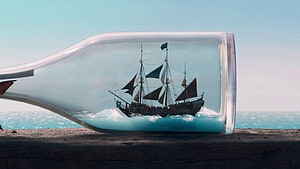 The Black Pearl Ship Inside a Glass Bottle on a Beach HD wallpaper