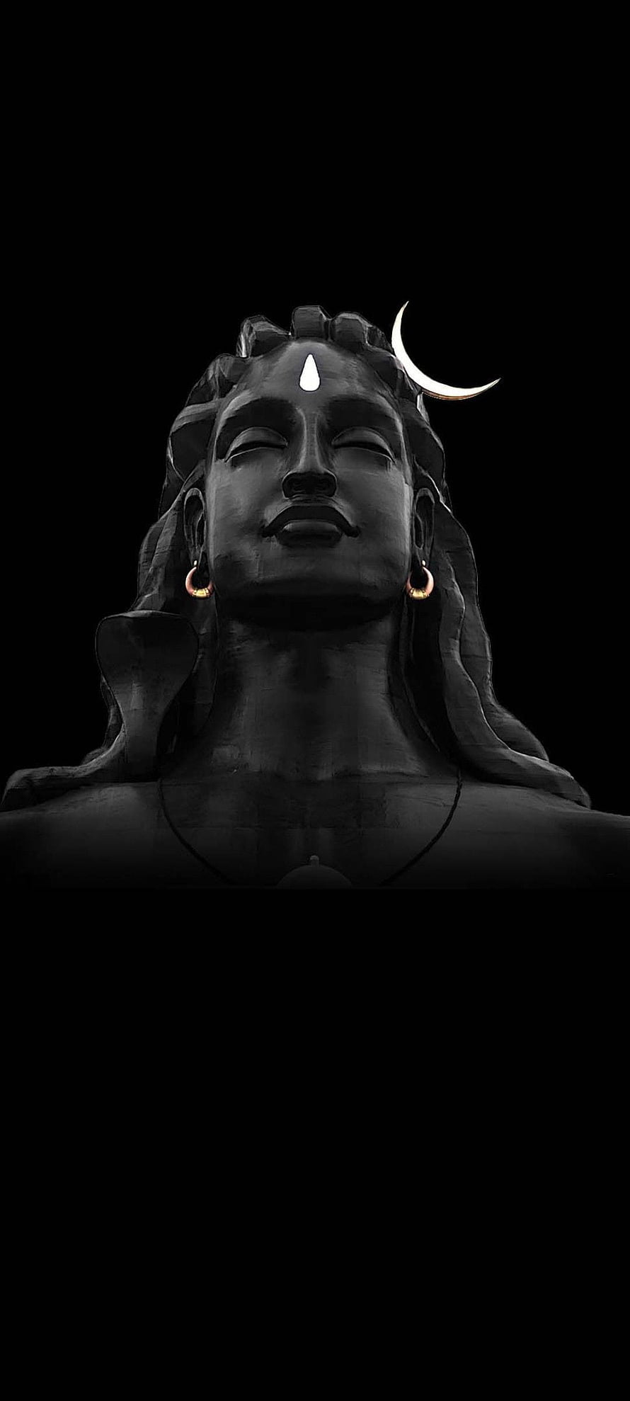 Serene Lord Shiva Statue with Crescent Moon and Third Eye on Black Background HD phone wallpaper
