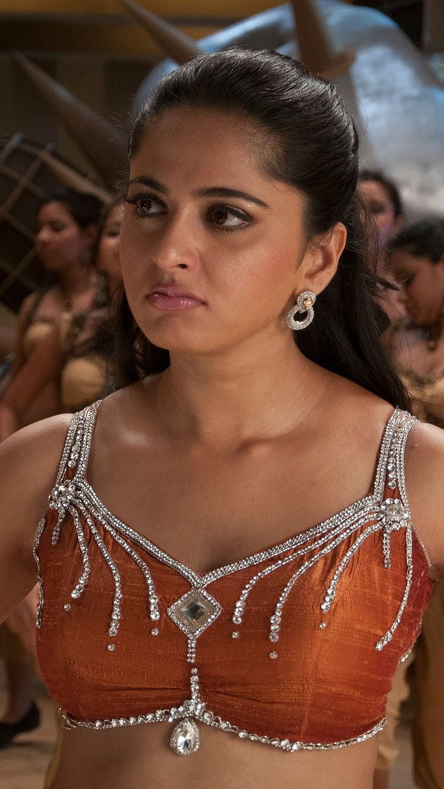 Anushka Shetty in ornate orange blouse with silver embellishments and traditional jewelry HD phone wallpaper