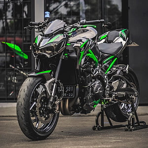 Kawasaki Z900 Black and Green Sport Motorcycle Parked on Stand HD phone wallpaper