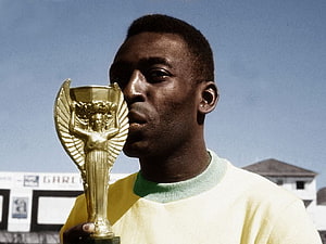 Pele Holding Golden Trophy in Yellow Jersey HD wallpaper