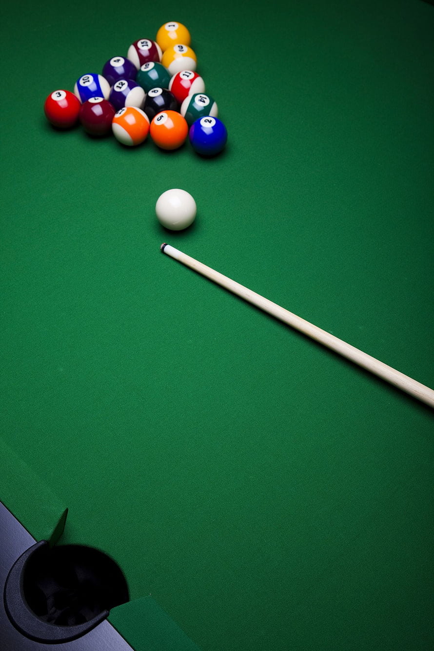 Pool table with racked balls, cue stick, and cue ball on green felt HD phone wallpaper