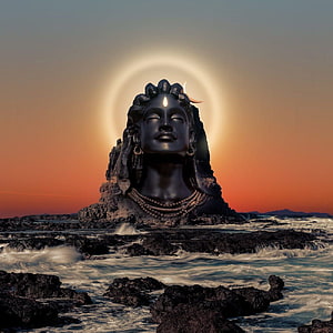 Adiyogi Statue With Glowing Halo At Sunset On Rocky Coastline HD phone wallpaper