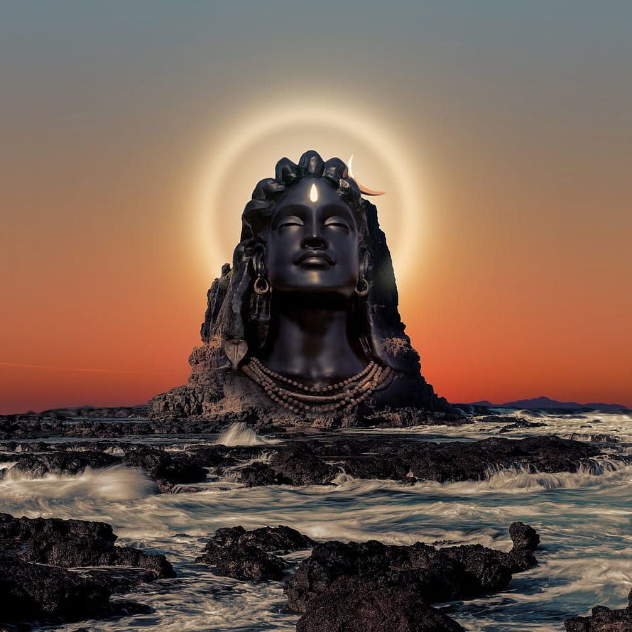 Adiyogi Statue With Glowing Halo At Sunset On Rocky Coastline HD phone wallpaper