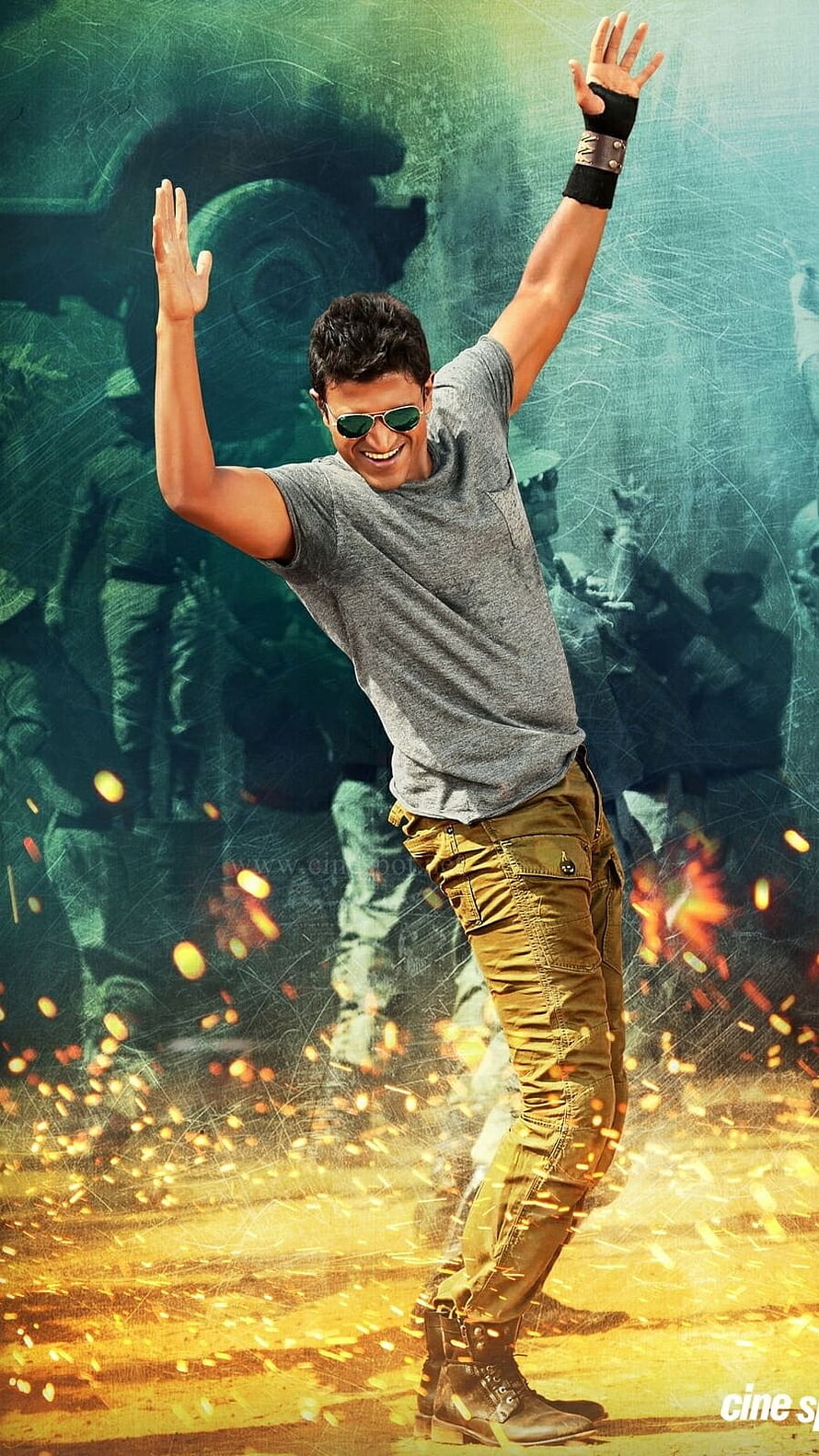 Puneeth Rajkumar in Action Pose with Raised Arms and Sparks HD phone wallpaper