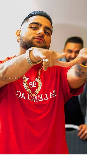 Karan Aujla in a red Balenciaga t-shirt with gold chain and watch HD phone wallpaper
