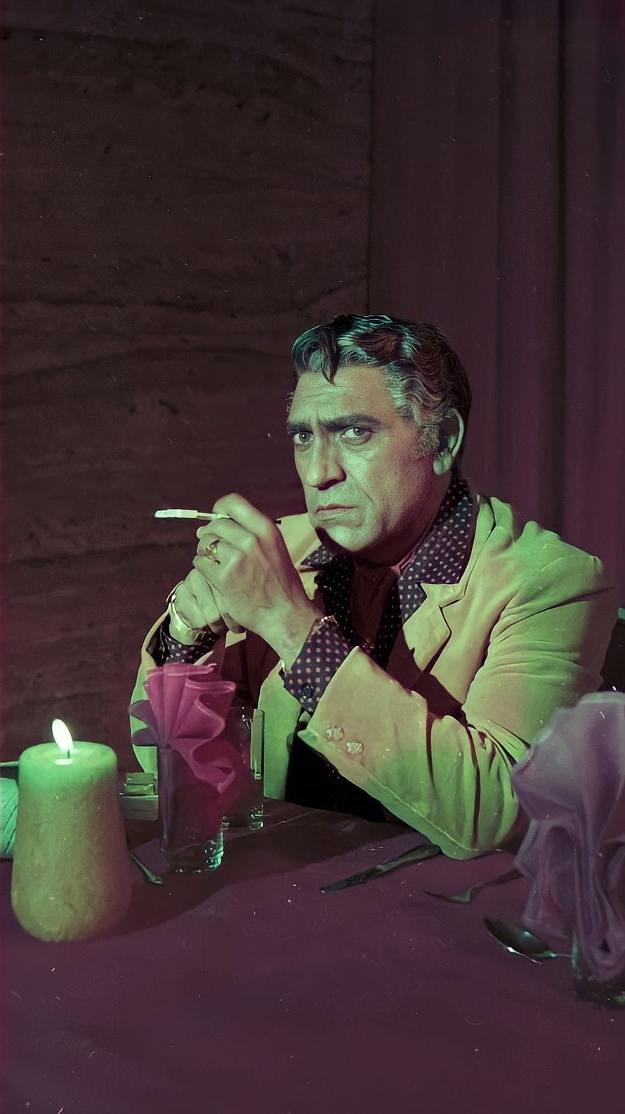 Amrish Puri in a moody candlelit scene wearing a light jacket and polka dot shirt HD phone wallpaper