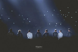 EXO Members Standing On Stage Under Dramatic Blue Spotlight Beams HD wallpaper