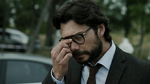 The Professor from Money Heist in a dark suit and glasses with a somber expression HD wallpaper