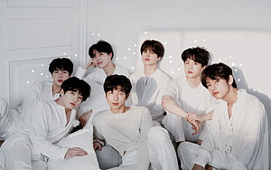 BTS Members in White Outfits Group Portrait with Star Accents HD wallpaper