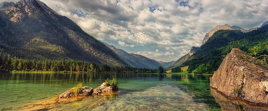 Serene Alpine Lake with Crystal Clear Waters and Forested Mountain Slopes HD wallpaper