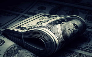 Stack of One Hundred Dollar Bills in Dark Moody Lighting HD wallpaper
