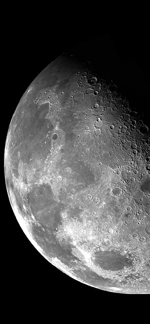 Detailed Close-Up of the Moon Surface with Craters and Lunar Terrain in Black and White HD phone wallpaper