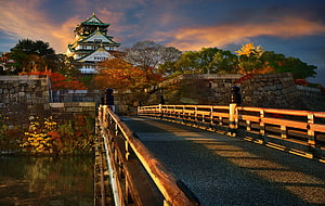 Osaka Castle at Golden Hour with Autumn Foliage and Stone Bridge HD wallpaper