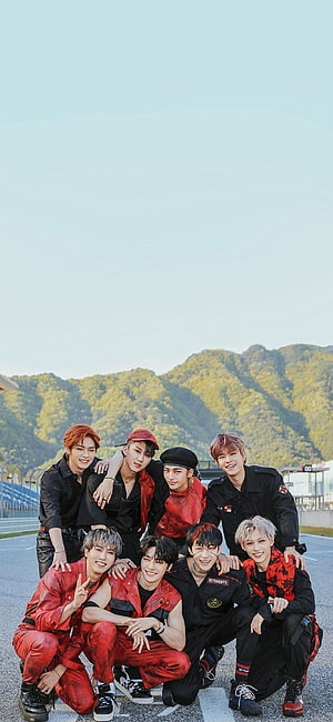 Stray Kids Group Photo in Red and Black Racing Outfits on a Track HD phone wallpaper