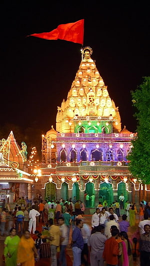 Ujjain Mahakal Temple Illuminated at Night with Red Flag and Crowded Courtyard HD phone wallpaper