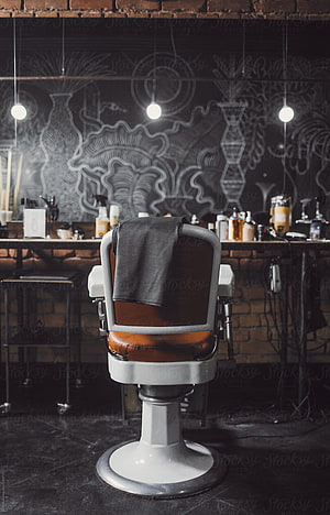 Vintage Barber Chair in Industrial Barbershop with Chalkboard Wall Art and Exposed Brick HD phone wallpaper