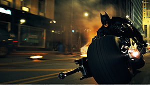 Batman on Batpod Motorcycle in Gotham City Night Chase Scene HD wallpaper
