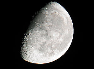 Gibbous Moon Phase with Craters and Lunar Surface Details Against Black Sky HD wallpaper