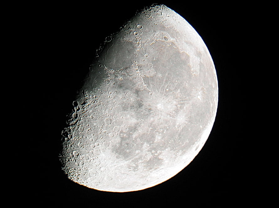 Gibbous Moon Phase with Craters and Lunar Surface Details Against Black Sky HD wallpaper
