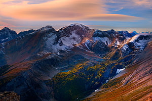 Snow-Capped Mountain Peaks at Golden Hour with Alpine Valley and Autumn Forest HD wallpaper