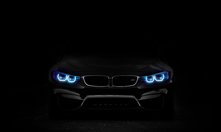 BMW M4 Front Fascade With Glowing Blue LED Headlights In Dark Studio Setting HD wallpaper