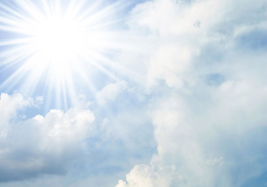 Bright Sunburst Breaking Through Soft White Clouds in a Pale Blue Sky HD wallpaper