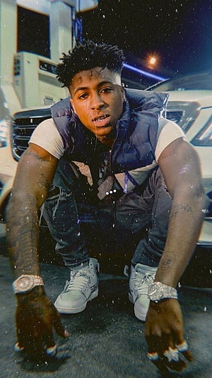 NBA YoungBoy Crouching in Front of Luxury SUV at Night with Snow Effect HD phone wallpaper