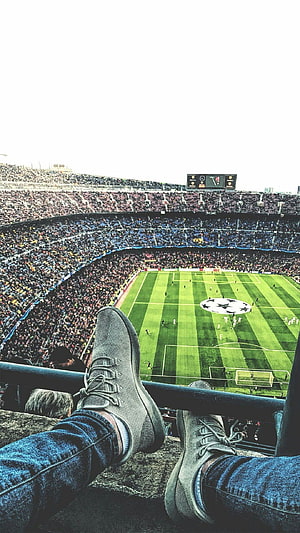 First Person View of a Football Match in a Packed Stadium with Sneakers in Foreground HD phone wallpaper