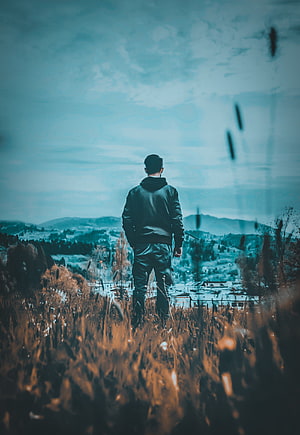 Man Standing in Autumn Field Gazing at Distant Town Under Moody Sky, Sad boy mood off, cloud, sky HD phone wallpaper