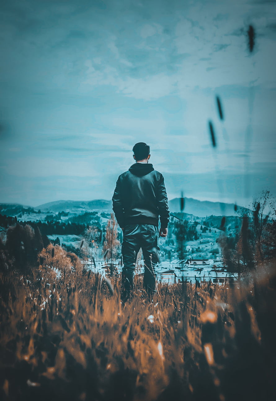 Man Standing in Autumn Field Gazing at Distant Town Under Moody Sky, Sad boy mood off, cloud, sky HD phone wallpaper