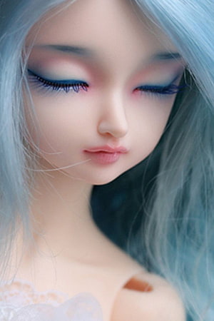 Close-up portrait of a realistic ball-jointed doll with pale blue hair and closed eyes HD phone wallpaper