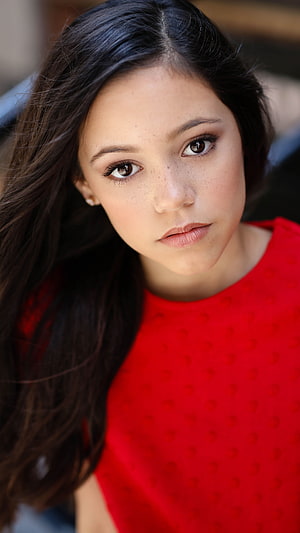Jenna Ortega Portrait in Red Top with Dark Hair and Freckles HD phone wallpaper