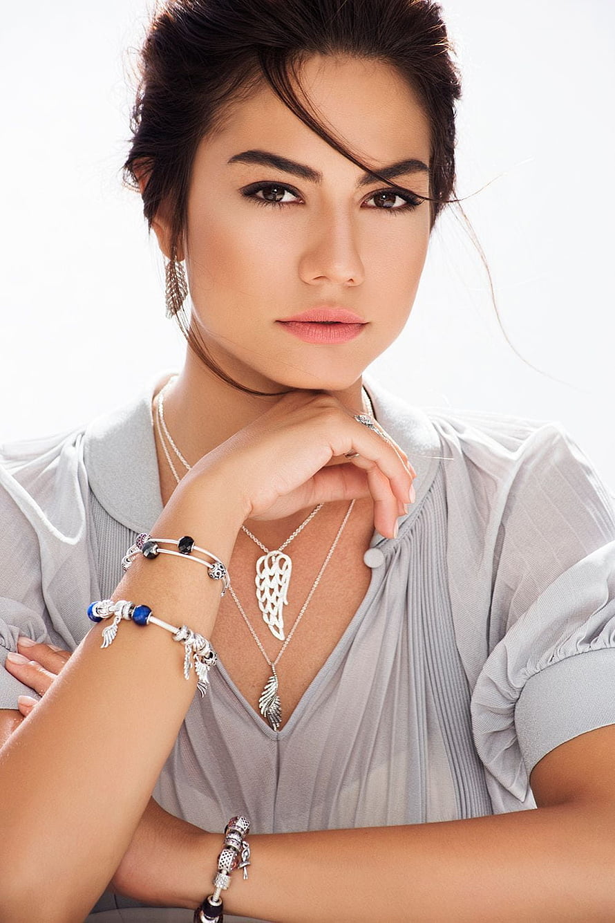 Demet Özdemir Studio Portrait Wearing Silver Feather Jewelry and Light Grey Blouse HD phone wallpaper
