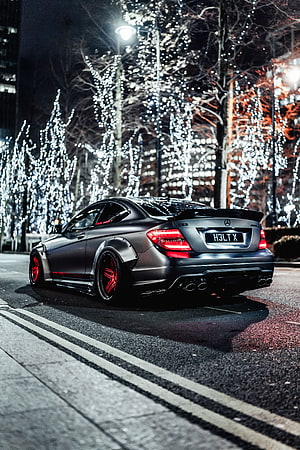 Matte Grey Mercedes-Benz C63 AMG Coupe with Red Rims Parked on a City Street at Night HD phone wallpaper
