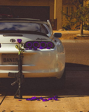 White Toyota Supra MK4 Rear View With Purple Rose And Rifle On Suburban Street HD phone wallpaper