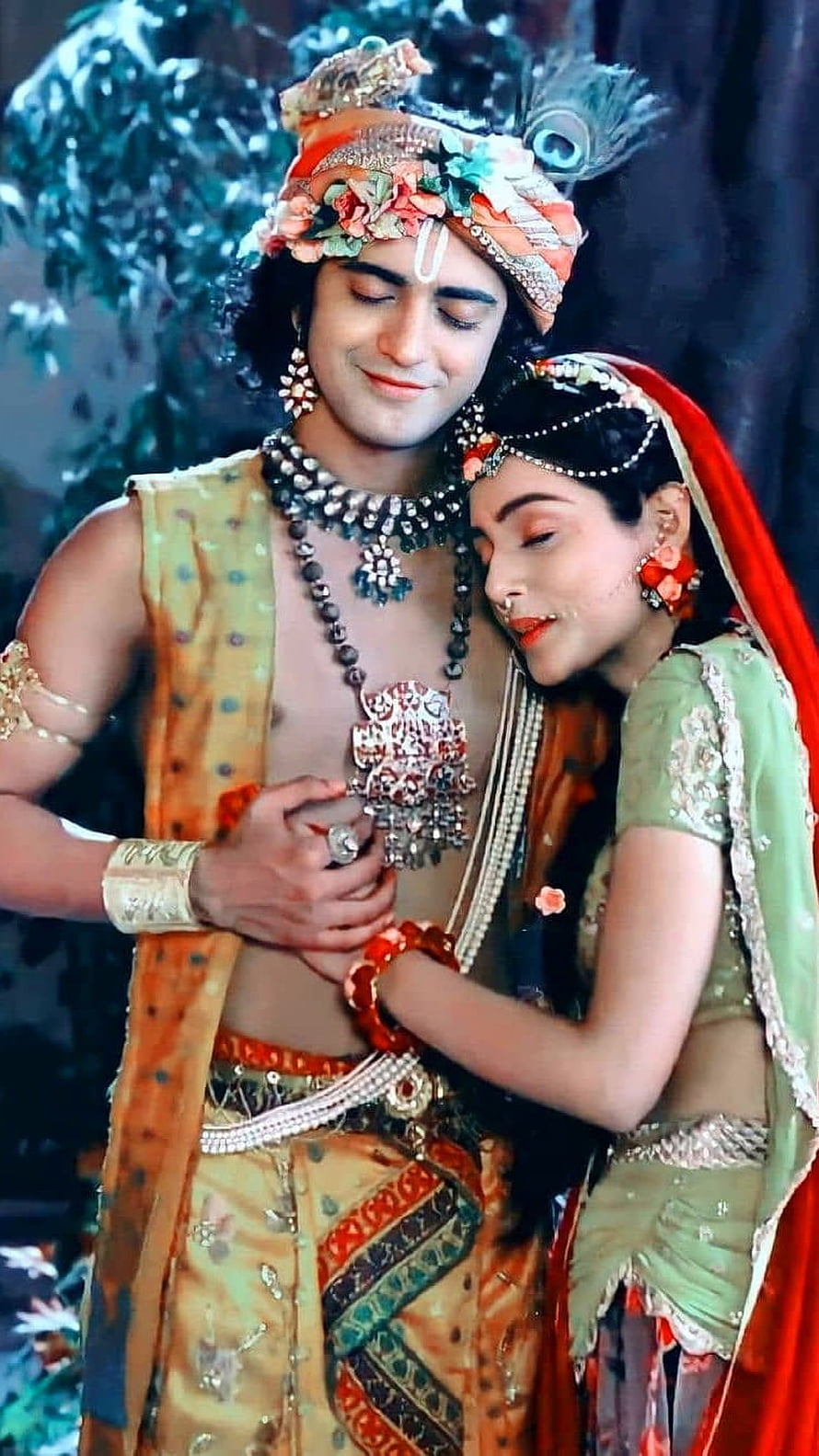 Radha Krishna in Traditional Indian Attire with Ornate Jewelry and Floral Headdress HD phone wallpaper