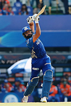 Rohit Sharma in Mumbai Indians blue kit executing a powerful cricket shot during IPL match HD phone wallpaper