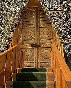 Ornate Golden Kaaba Door with Arabic Calligraphy and Carpeted Staircase HD phone wallpaper
