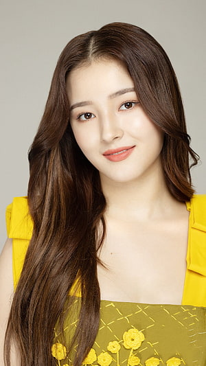 Nancy Momoland Portrait in Yellow Floral Dress with Long Wavy Hair HD phone wallpaper