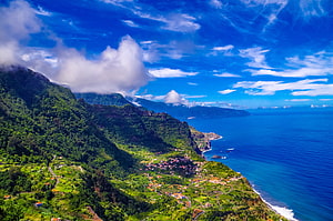 Aerial View of Lush Coastal Mountains and Village in Madeira, Portugal HD wallpaper