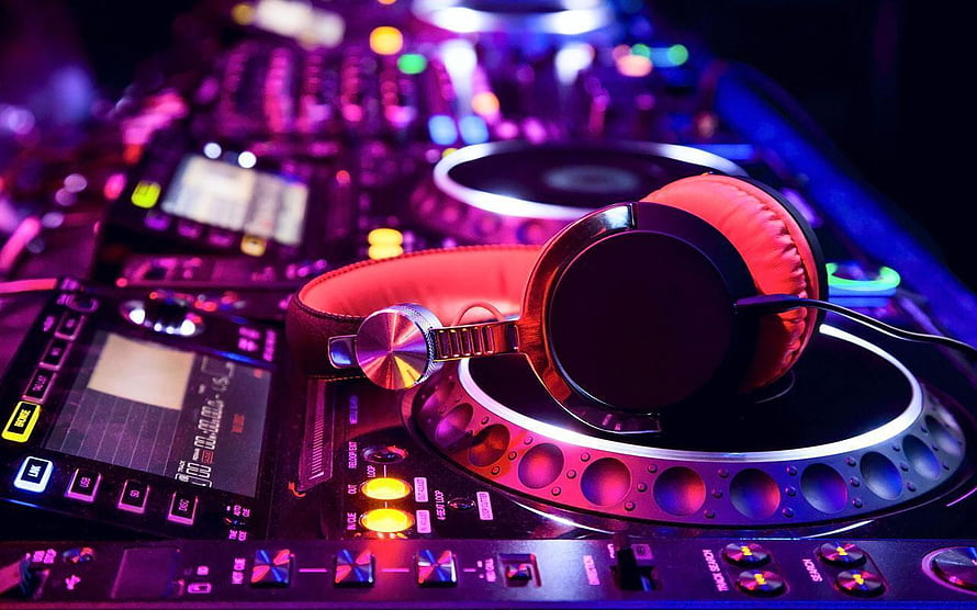 DJ Headphones Resting on Turntable with Neon Club Lighting and Mixing Console HD wallpaper
