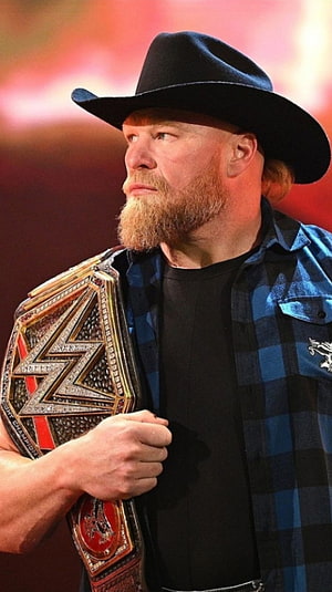 Brock Lesnar in Cowboy Hat and Plaid Shirt Holding WWE Championship Belt HD phone wallpaper