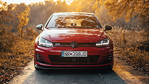 Red Volkswagen Golf GTI Front View on Autumn Country Road at Golden Hour HD wallpaper